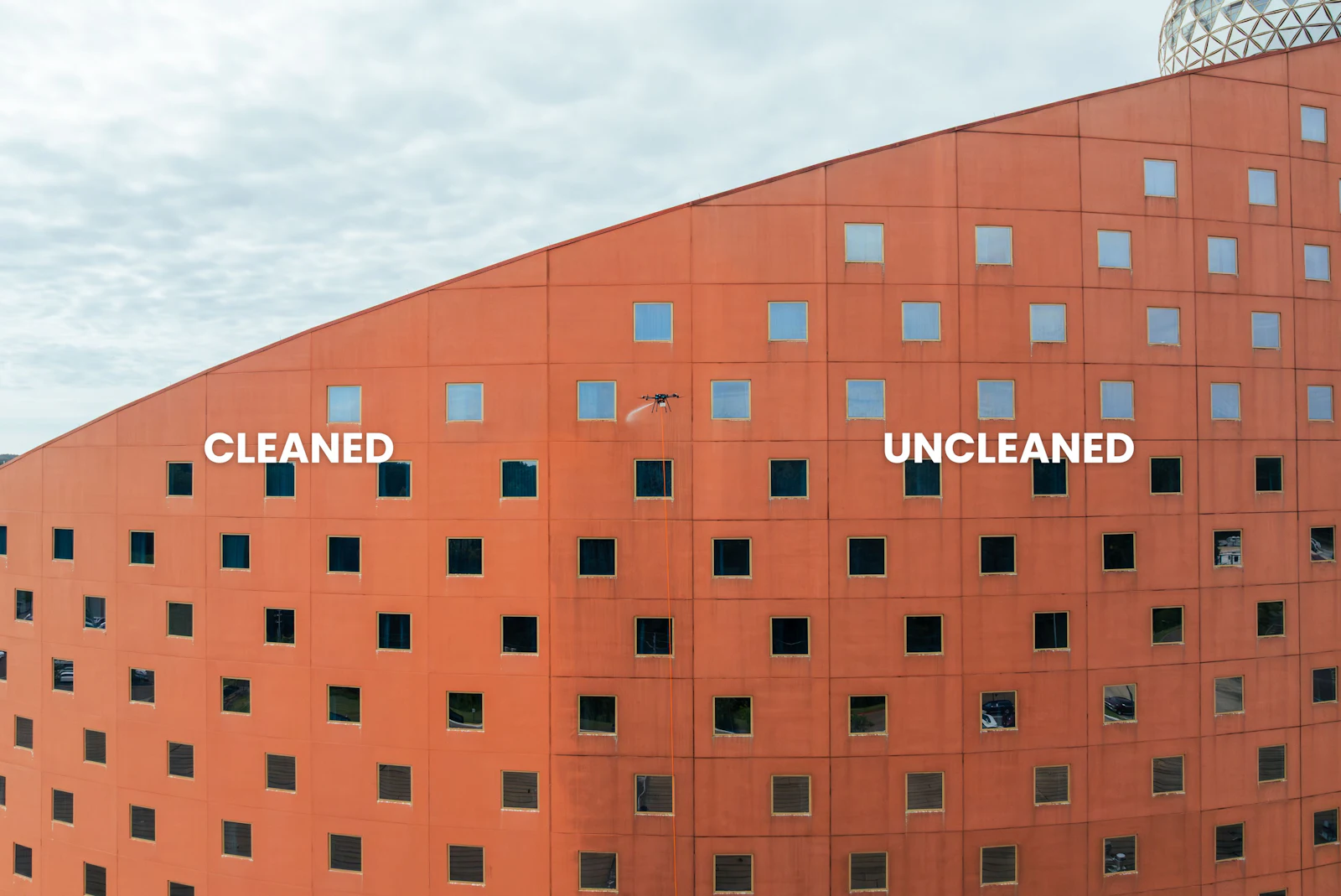 Close-up of the Pearl River Resort tower facade showing the cleaned and uncleaned sections